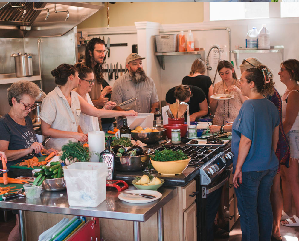 teaching a cooking workshop in a commercial kitchen